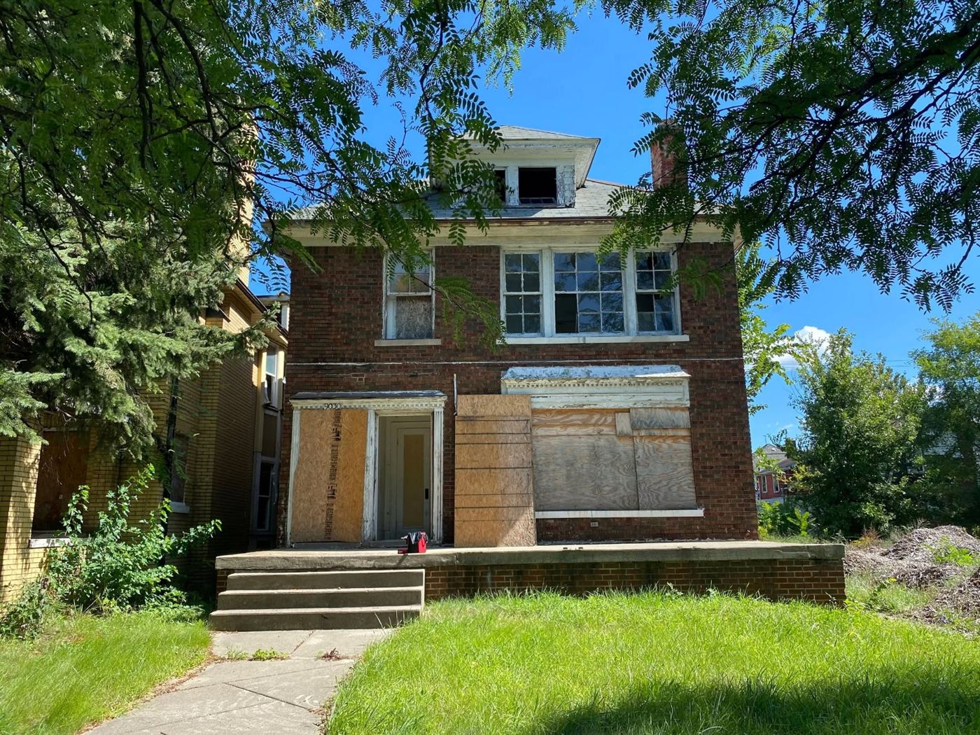 A two-story Detroit brick home under restoration by Denson Construction